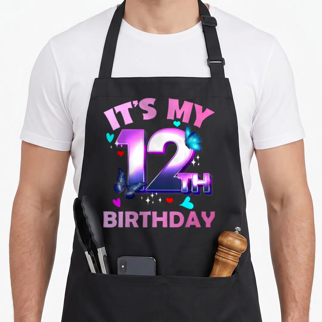 12th birthday butterfly aprons - IT'S MY 12 TH BIRTHDAY text with blue butterflies and hearts in pink purple and blue — shown on a black cotton canvas apron against a white background