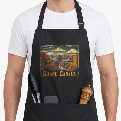 Grand canyon us aprons - Retro Grand Canyon landscape with river, clouds, and orange brown blue yellow colors — shown on a black cotton canvas apron against a white background