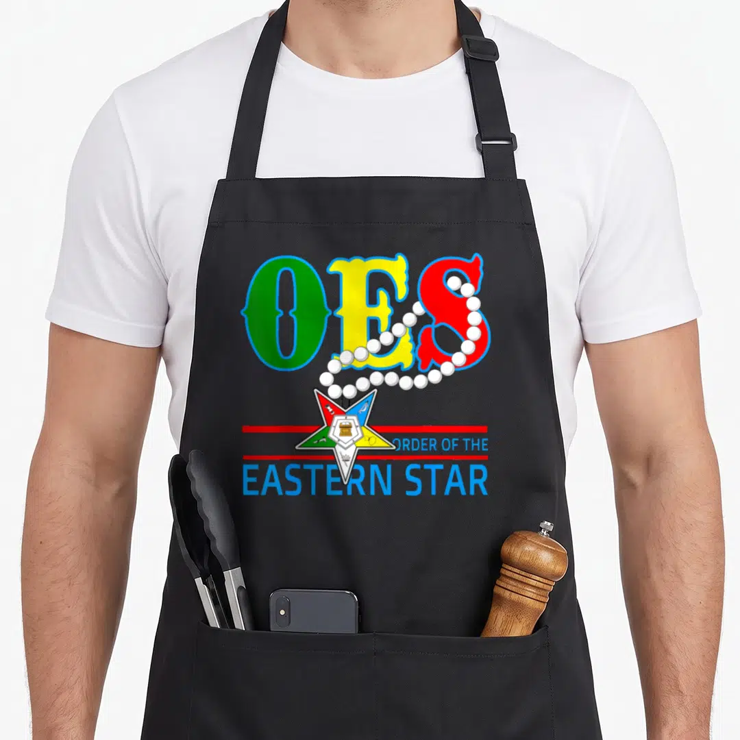 Oes beautiful apron - Colorful OES letters with white pearls draped over a five-pointed Order of the Eastern Star emblem — shown on a black cotton canvas apron against a white background