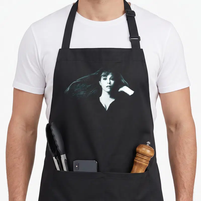 Mariah baggy apron - Woman portrait in dark teal and white line art sketch style — shown on a black cotton canvas apron against a white background