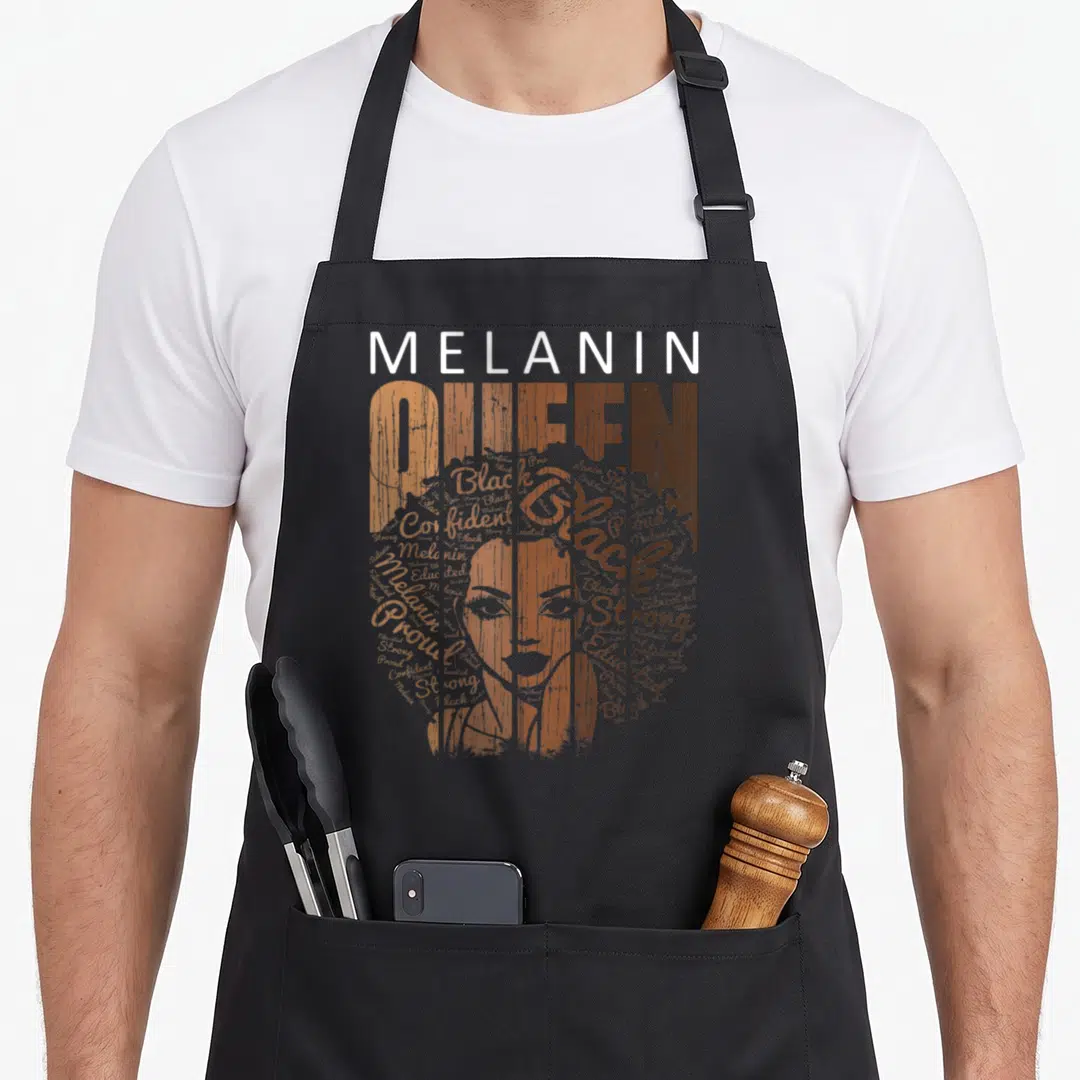 Melanin african american aprons - Melanin Queen text forming a woman's face using words Strong Proud Confident Educated — shown on a black cotton canvas apron against a white background