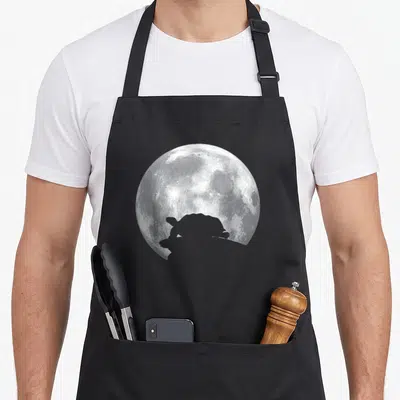Turtle russian apron - White and grey full moon with a dark turtle silhouette overlapping the bottom edge — shown on a black cotton canvas apron against a white background