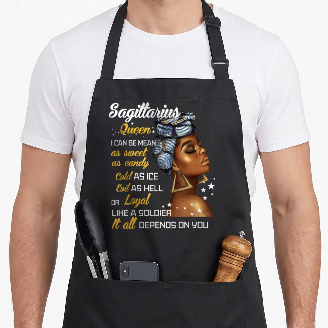 Sagittarius queen birthday apron - Realistic woman with headwrap and text I can be mean as sweet as candy — shown on a black cotton canvas apron against a white background