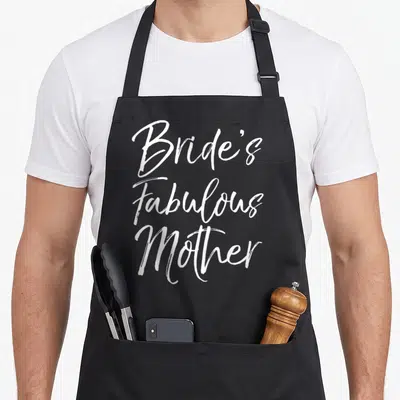 Bride fabulous bridal apron - White script text reading Bride's Fabulous Mother stacked vertically — shown on a black cotton canvas apron against a white background