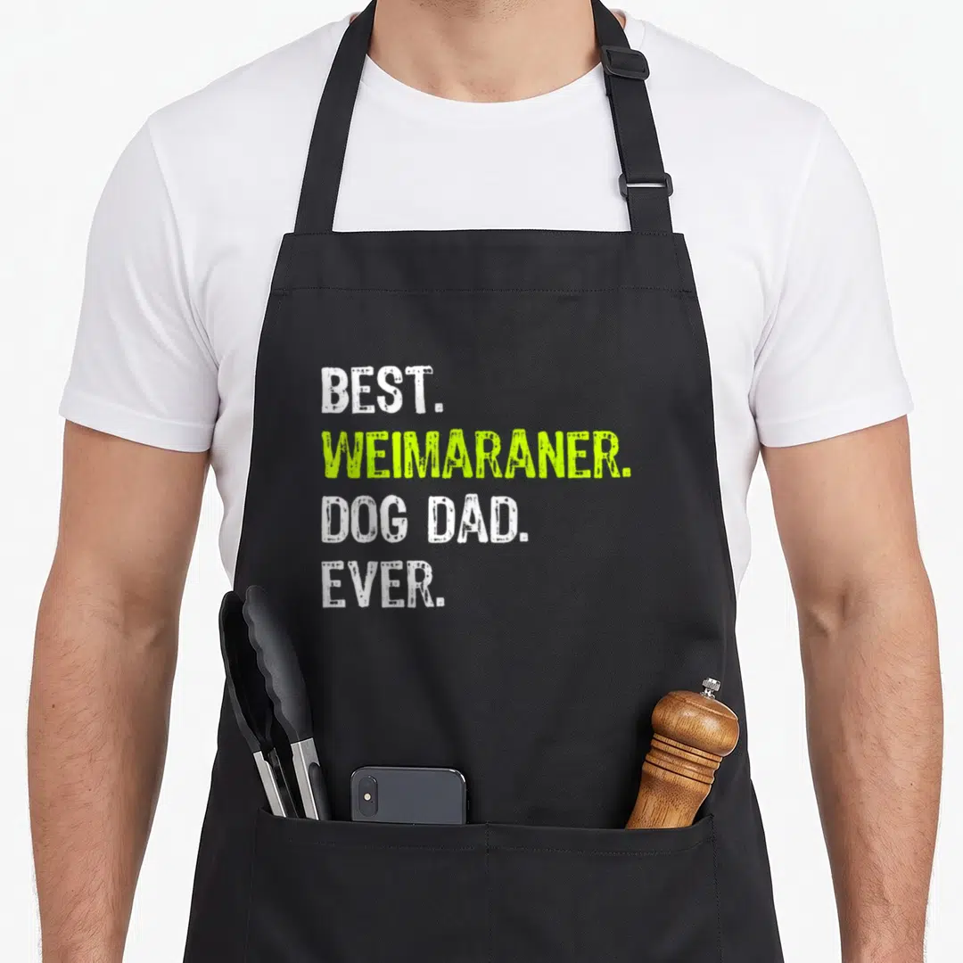 Weimaraner father day apron - Stacked white and lime green text reading BEST WEIMARANER DOG DAD EVER — shown on a black cotton canvas apron against a white background