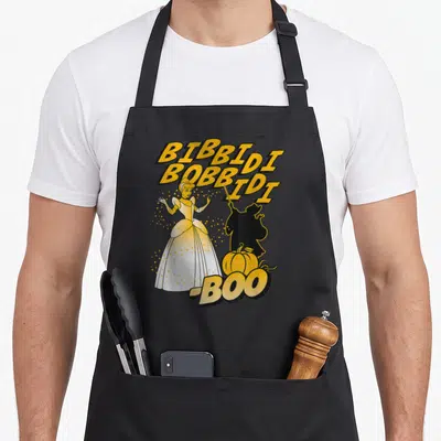 Bibbidi halloween apron - Cinderella cartoon with yellow stacked text BIBBIDI BOBBIDI BID I BOO and black silhouette — shown on a black cotton canvas apron against a white background