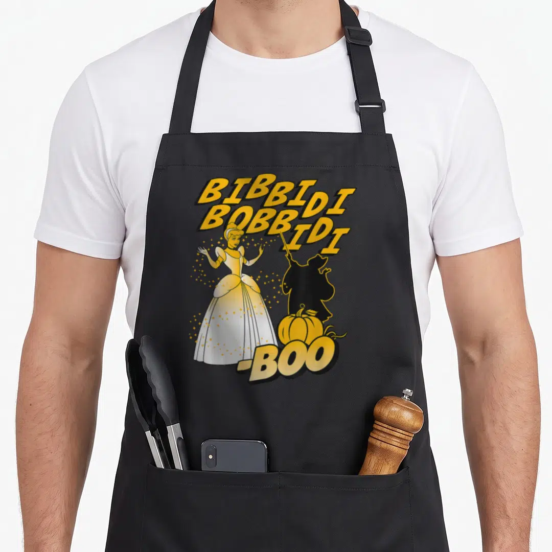 Bibbidi halloween apron - Cinderella cartoon with yellow stacked text BIBBIDI BOBBIDI BID I BOO and black silhouette — shown on a black cotton canvas apron against a white background