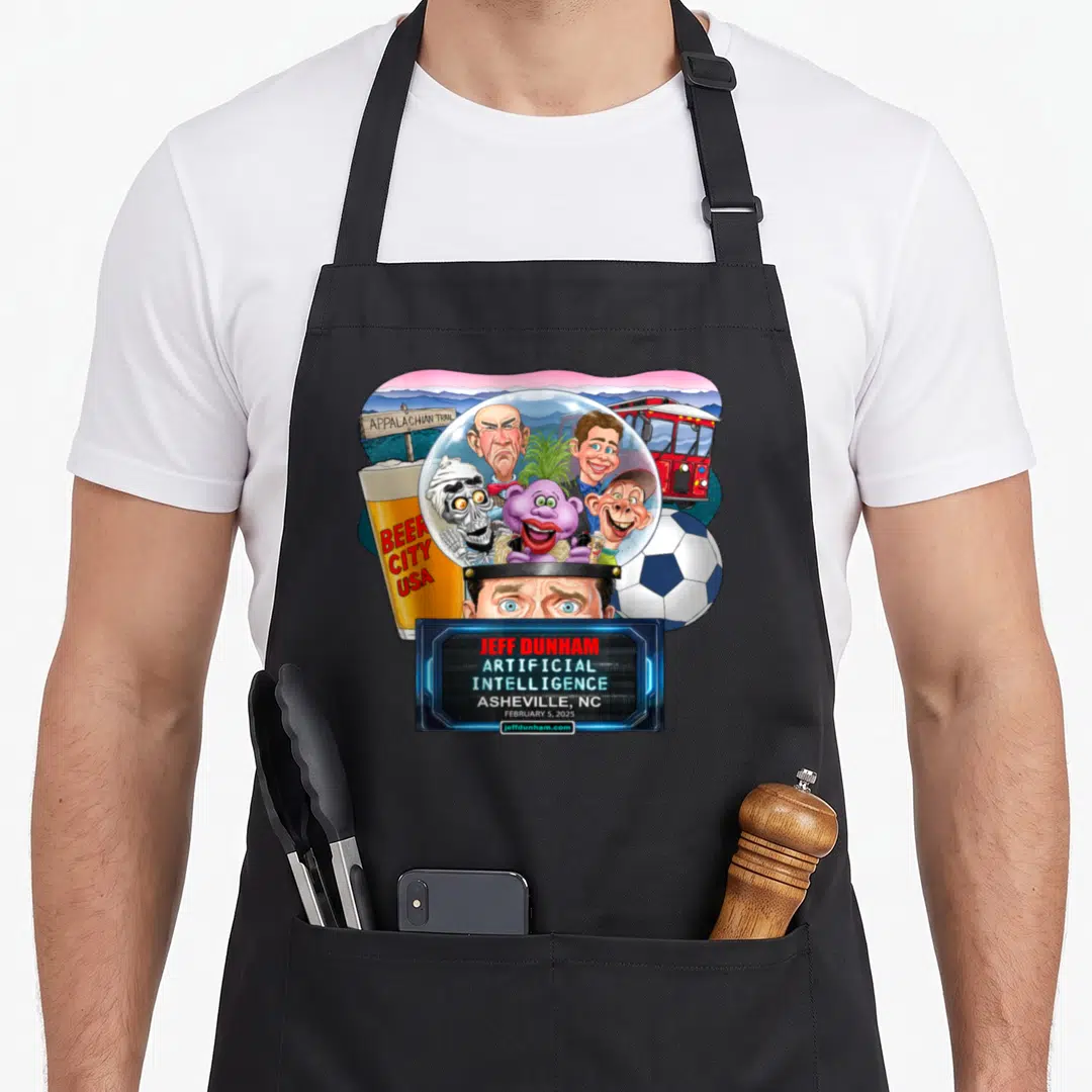 Dunham asheville apron - Jeff Dunham characters in dome with beer glass, soccer ball, bus, and Artificial Intelligence — shown on a black cotton canvas apron against a white background