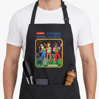 Zombie steven rhodes apron - Three cartoon children holding weapons over zombie parts with MY FIRST ZOMBIE APOCALYPSE — shown on a black cotton canvas apron against a white background