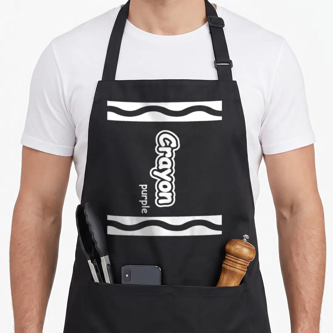 Crayon easy apron - Vertical white Crayon purple text with two wavy horizontal bands — shown on a black cotton canvas apron against a white background