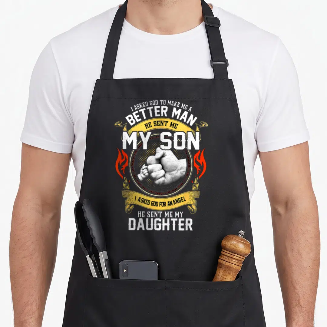 Asked better good apron - Distressed text about son and daughter with adult hand holding baby hand and red flames — shown on a black cotton canvas apron against a white background