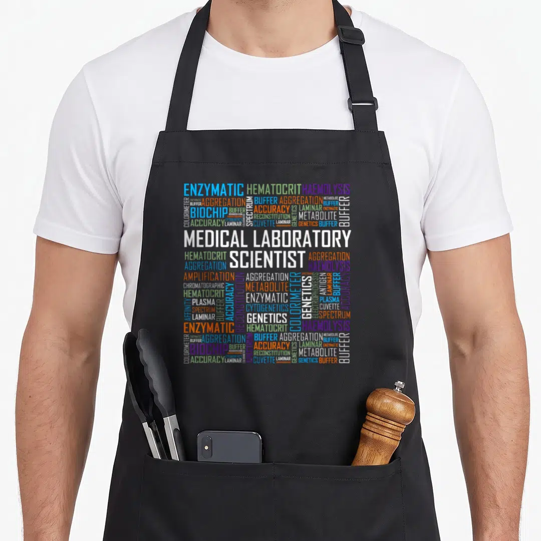 Cls laboratory apron - MEDICAL LABORATORY SCIENTIST word cloud with ENZYMATIC HEMATOCRIT BIOCHIP text in white orange — shown on a black cotton canvas apron against a white background
