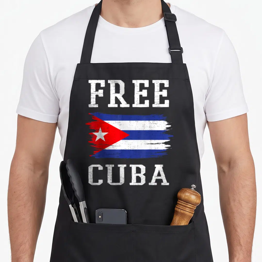 Soscuba cuba libre apron - Distressed Cuba flag between white FREE and CUBA text in blue red stripes — shown on a black cotton canvas apron against a white background
