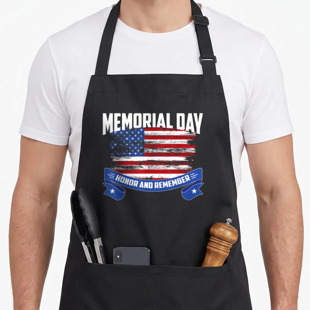 Memorial english class apron - Distressed USA flag with MEMORIAL DAY text and blue ribbon saying HONOR AND REMEMBER — shown on a black cotton canvas apron against a white background