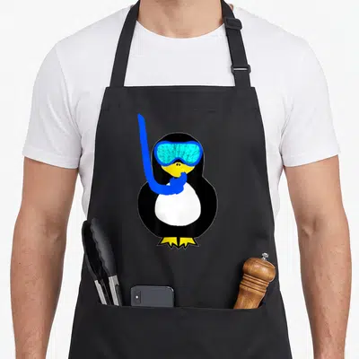 Snorkel bird apron - Cartoon penguin in black and white with blue goggles and yellow feet — shown on a black cotton canvas apron against a white background