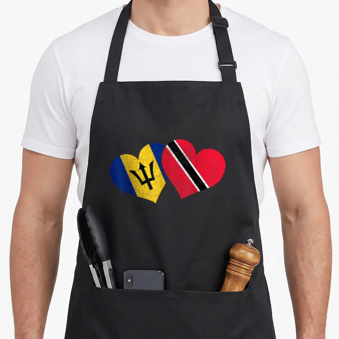 Barbado pride apron - Two overlapping hearts with Barbados and Trinidad and Tobago flags in blue yellow red white black — shown on a black cotton canvas apron against a white background