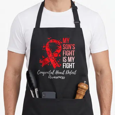 Son congenital heart defect apron - Red heart ribbon with My Son's Fight Is My Fight text and Congenital Heart Defect — shown on a black cotton canvas apron against a white background