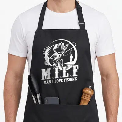 Milf fisherman fishing aprons - White line art of leaping fish and angler with text MAN I LOVE FISHING — shown on a black cotton canvas apron against a white background