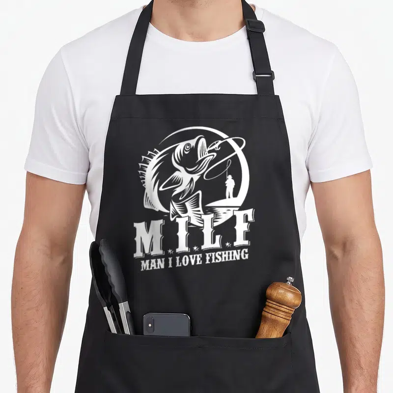 Milf fisherman fishing aprons - White line art of leaping fish and angler with text MAN I LOVE FISHING — shown on a black cotton canvas apron against a white background