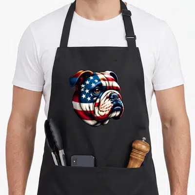 Owner american flag apron - Realistic bulldog head with skin replaced by blue red and white flag pattern — shown on a black cotton canvas apron against a white background