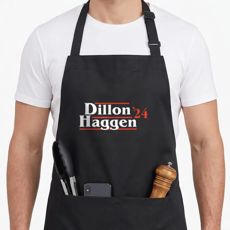 Dillon sheriff apron - White and red stacked text reading Dillon 24 Haggen with horizontal lines — shown on a black cotton canvas apron against a white background