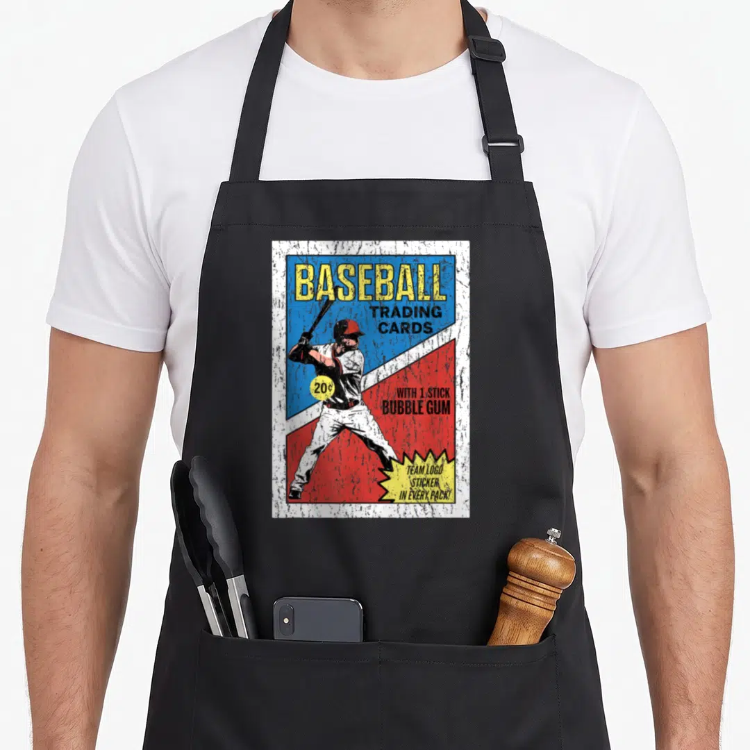 Wrapper baseball apron - Retro baseball player on blue and red background with trading cards and bubble gum text — shown on a black cotton canvas apron against a white background