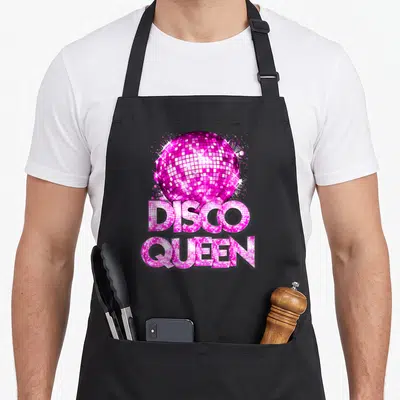 Queen themed 70s apron - Pink disco ball above DISCO QUEEN text with mirrored tile pattern — shown on a black cotton canvas apron against a white background