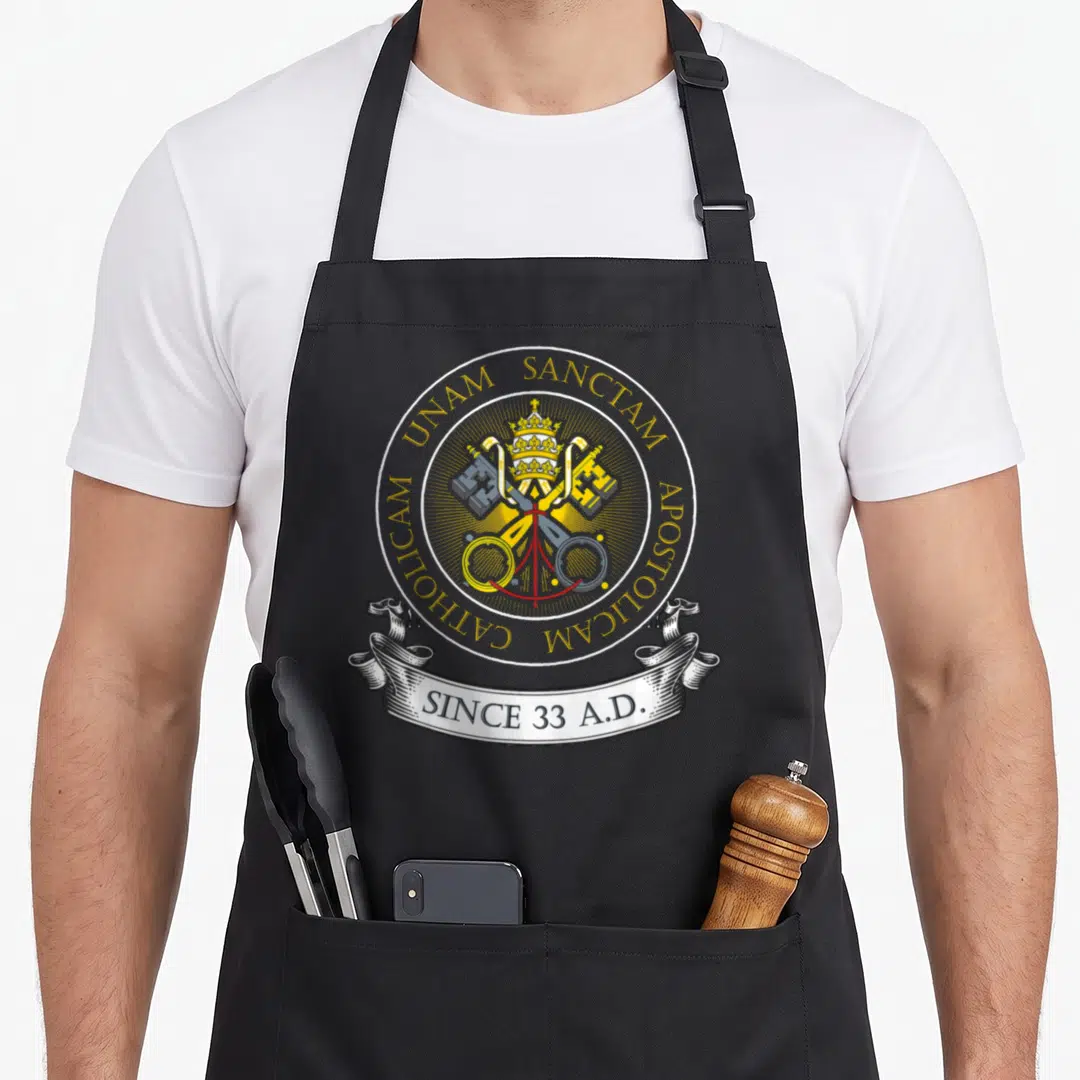 Holy catholic apron - Papal tiara crossed keys gold ring unam sanctam since 33 ad ribbon — shown on a black cotton canvas apron against a white background