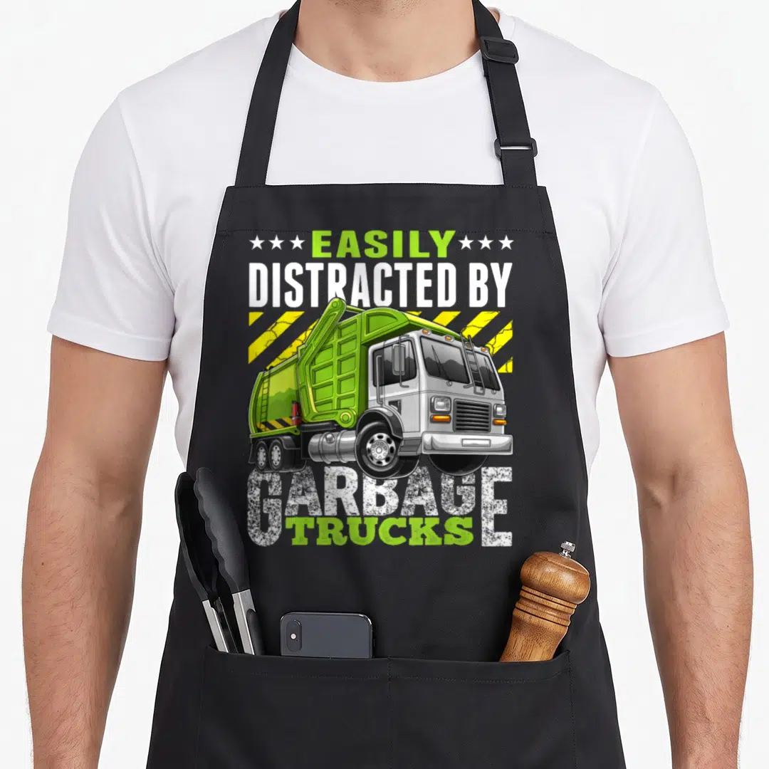 Easily distracted truck apron - Cartoon lime green garbage truck with yellow stripes and text EASILY DISTRACTED — shown on a black cotton canvas apron against a white background