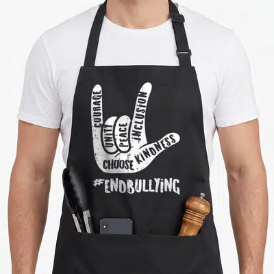 End unity day apron - White distressed hand sign filled with COURAGE UNITY PEACE INCLUSION CHOOSE KINDNESS #ENDBULLYING — shown on a black cotton canvas apron against a white background