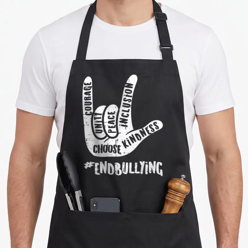 End unity day apron - White distressed hand sign filled with COURAGE UNITY PEACE INCLUSION CHOOSE KINDNESS #ENDBULLYING — shown on a black cotton canvas apron against a white background
