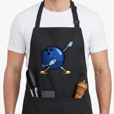 Ball pins for aprons - Blue cartoon bowling ball character with raised arm and yellow red shoes — shown on a black cotton canvas apron against a white background