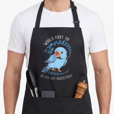 Aaa bird apron - Cartoon blue parrot with screaming A text and sarcastic quote — shown on a black cotton canvas apron against a white background