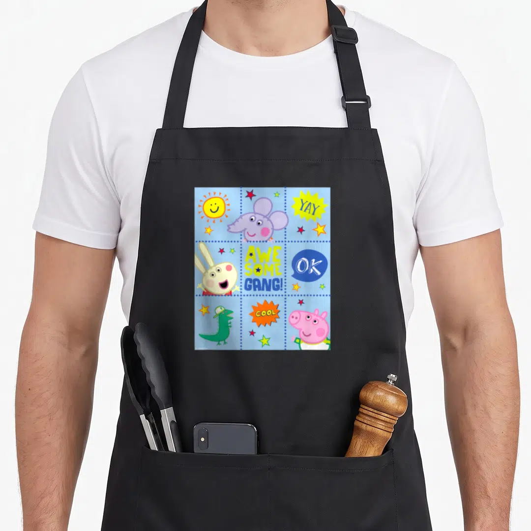 George crew apron - Peppa Pig characters and Awesome Gang text in blue dotted grid panels — shown on a black cotton canvas apron against a white background