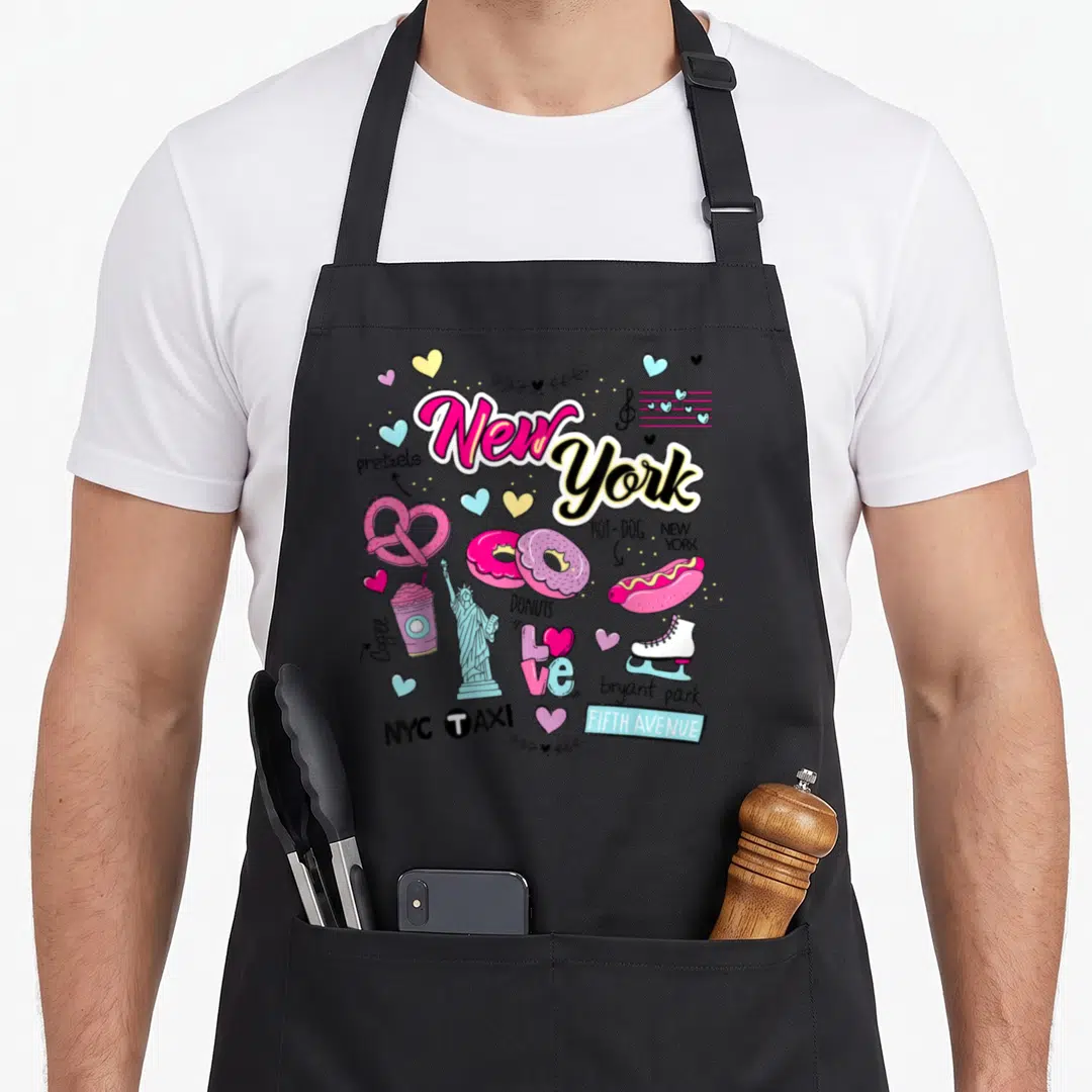 Funny illustration new york apron - Cartoon New York collage with pretzels, hot dogs, Statue of Liberty, and text — shown on a black cotton canvas apron against a white background