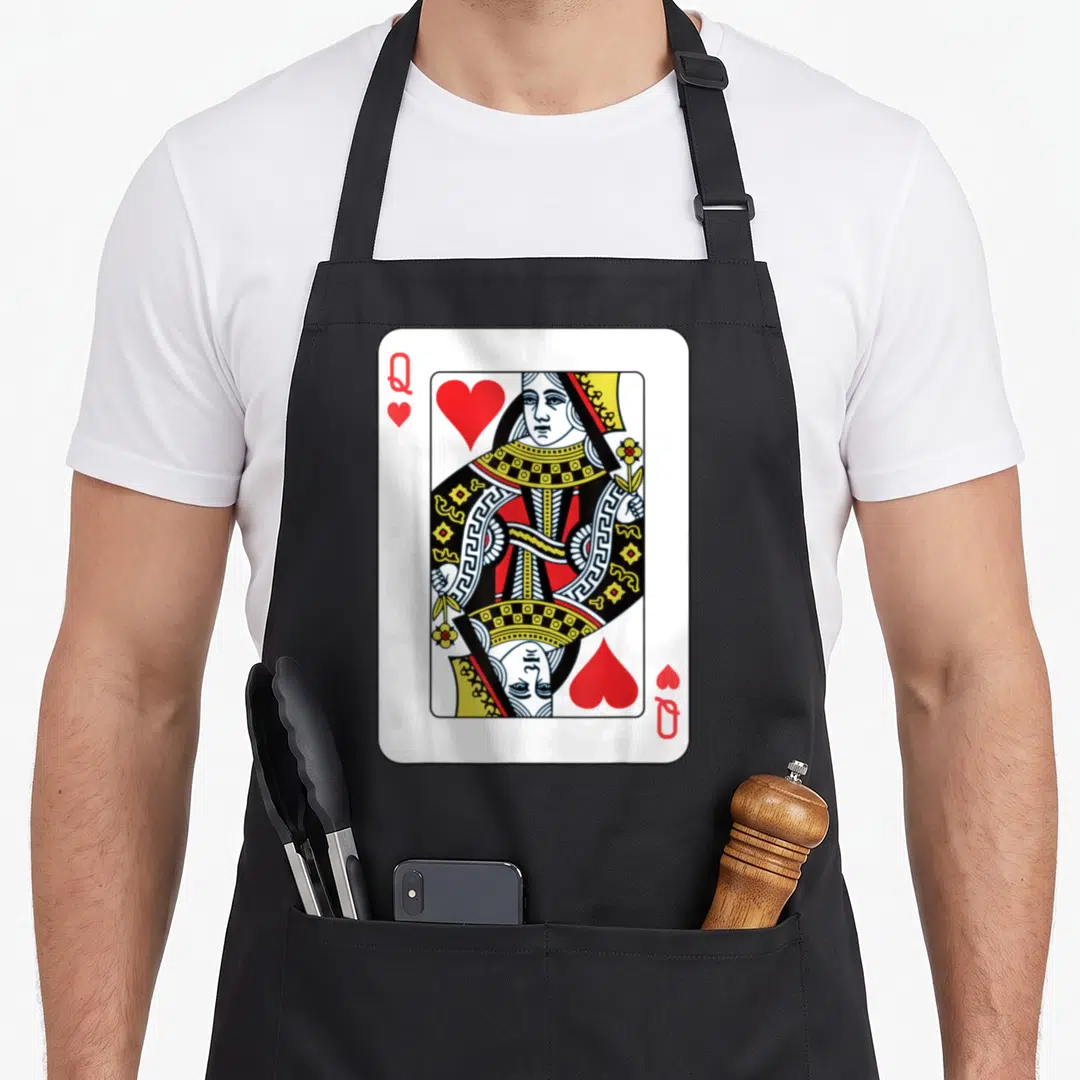 Playing queen apron - Queen of Hearts playing card with mirrored portrait red hearts and Q in corners — shown on a black cotton canvas apron against a white background