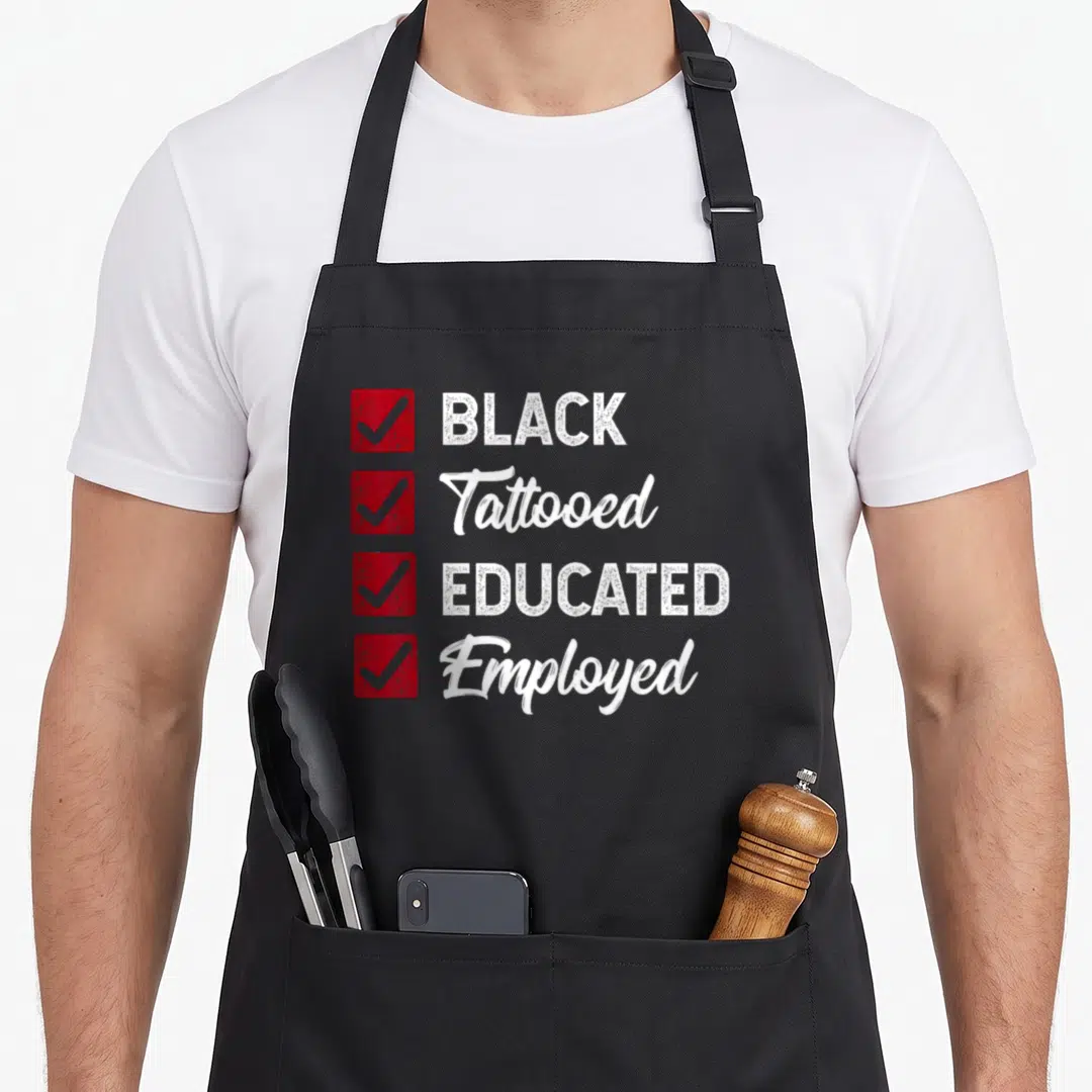 Employed political aprons - Checklist with red boxes and white text reading BLACK Tattooed EDUCATED Employed — shown on a black cotton canvas apron against a white background