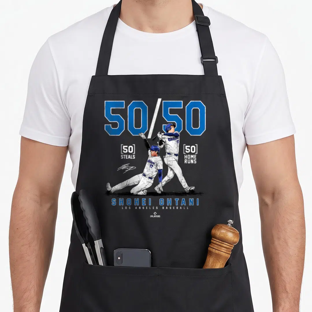 Ohtani mvp apron - Shohei Ohtani 50-50 stats, two action poses, blue and grey distressed text — shown on a black cotton canvas apron against a white background