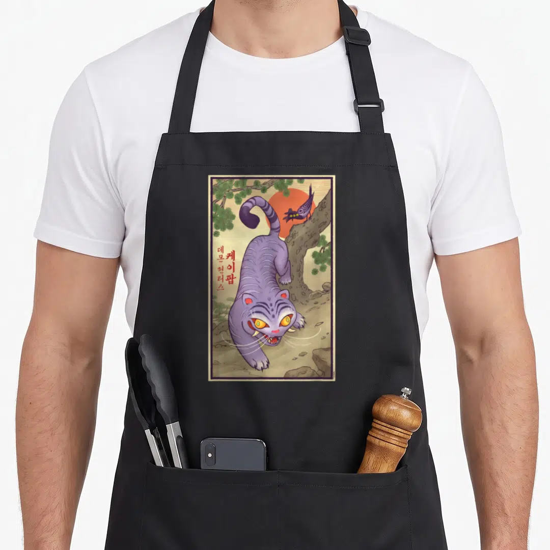Derpy traditional apron - Purple cat, red sun, bird on branch, Korean text on left side — shown on a black cotton canvas apron against a white background