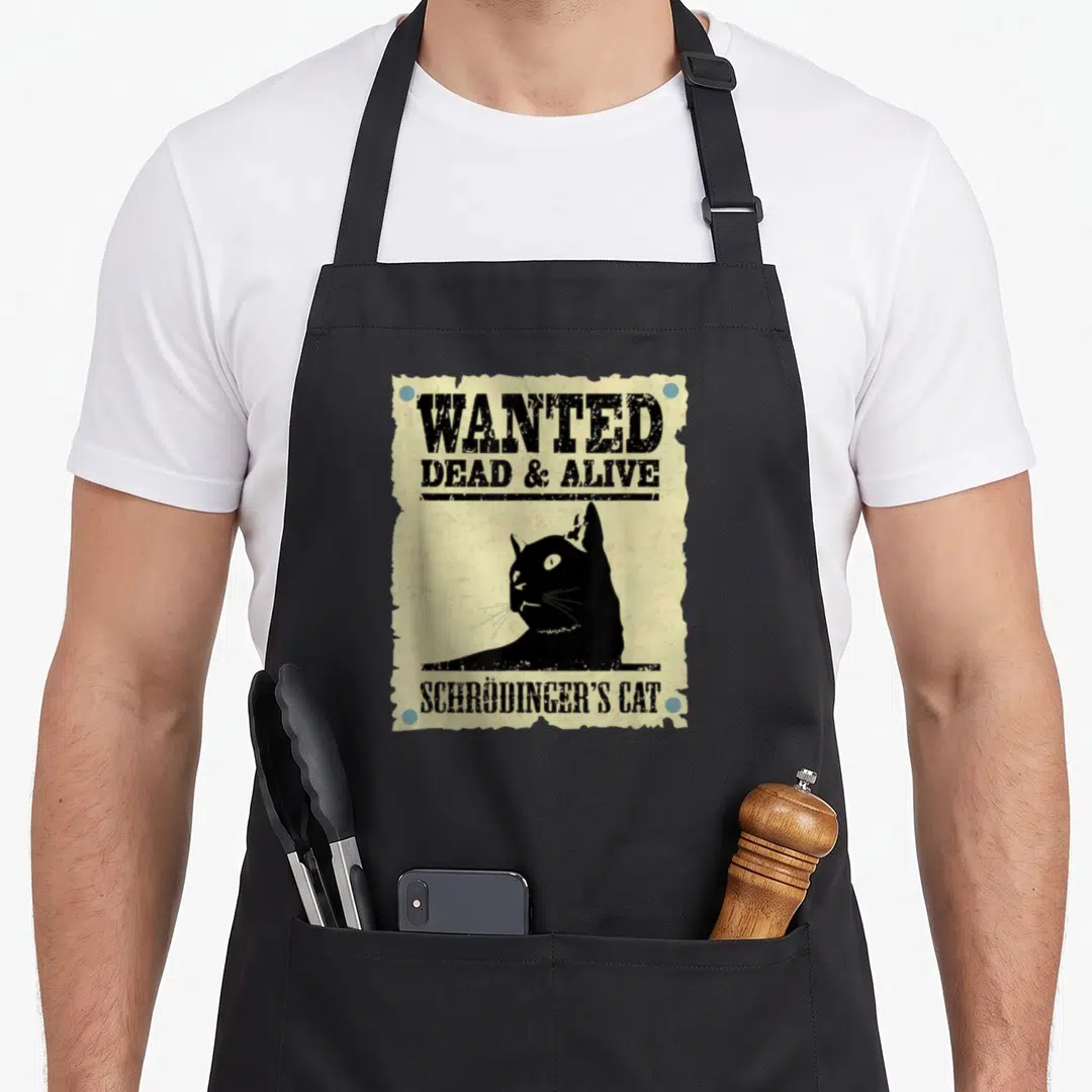 Physic cat apron - Black cat silhouette on beige wanted poster with blue rivets and distressed text reading Wanted Dead — shown on a black cotton canvas apron against a white background