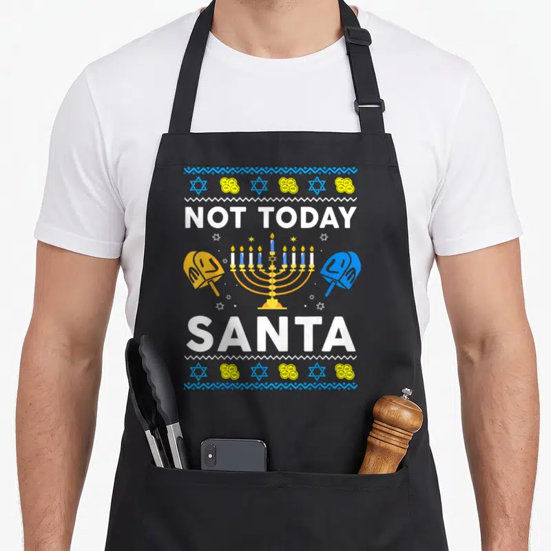 Ugly jewish apron - Not Today Santa text with menorah, two kippahs, stars and coins in blue and gold — shown on a black cotton canvas apron against a white background