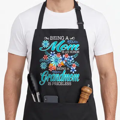 Honor coastal grandmother apron - Cyan and red watercolor flowers separating text about mom and grandmom honors — shown on a black cotton canvas apron against a white background