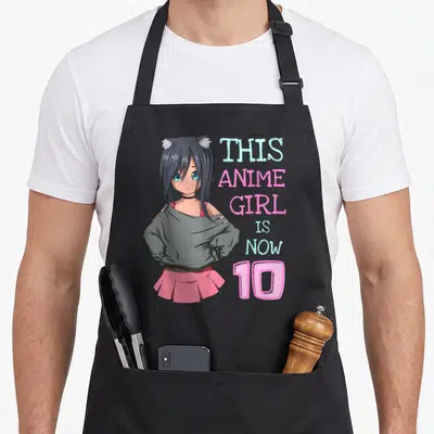 Birthday anime mom apron - Anime girl with cat ears and pink skirt beside stacked pink and blue text reading This Anime — shown on a black cotton canvas apron against a white background