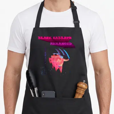 Paranoid black officially apron - Stacked magenta Black Sabbath Paranoid text above distorted red and blue figure — shown on a black cotton canvas apron against a white background