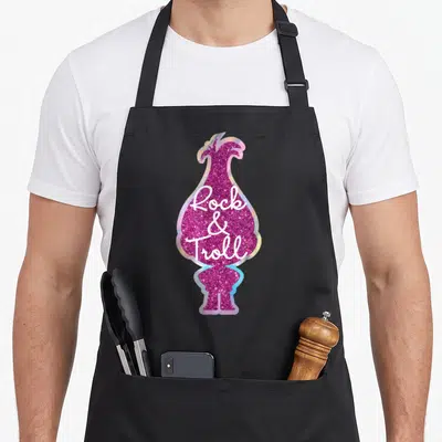 Troll foam rolling apron - Pink glittery troll silhouette with white Rock and Troll script — shown on a black cotton canvas apron against a white background