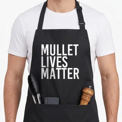 Mullet hillbilly apron - White stacked text reading MULLET LIVES MATTER on grey background — shown on a black cotton canvas apron against a white background
