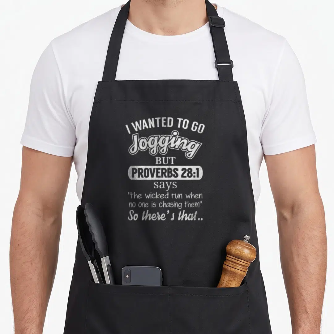 Jogging jogger apron - White stacked typography reading I wanted to go jogging but proverbs 28 1 says the wicked run — shown on a black cotton canvas apron against a white background