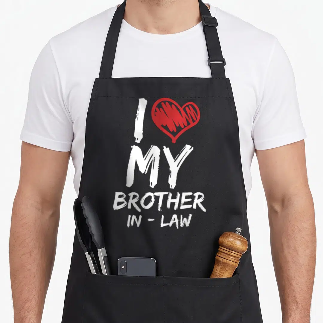 Vintage brother in law apron - White I MY BROTHER IN-LAW text next to a red scribbled heart — shown on a black cotton canvas apron against a white background