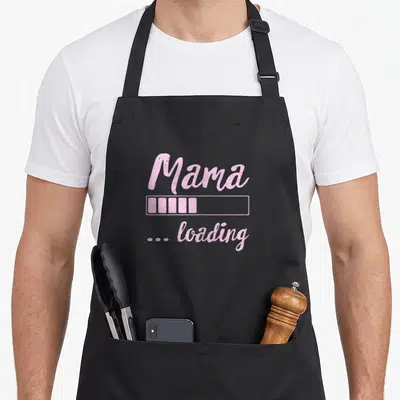 Loading mother's apron - Pink distressed text reading Mama with a loading bar and ... loading — shown on a black cotton canvas apron against a white background