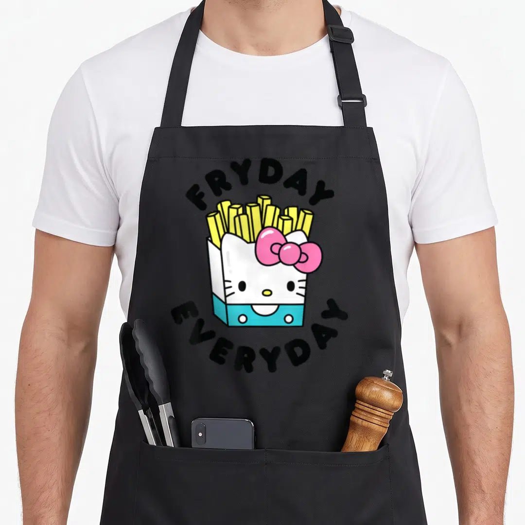Fryday french apron - Cartoon Hello Kitty fry box with FRYDAY EVERYDAY text in white yellow pink blue black — shown on a black cotton canvas apron against a white background